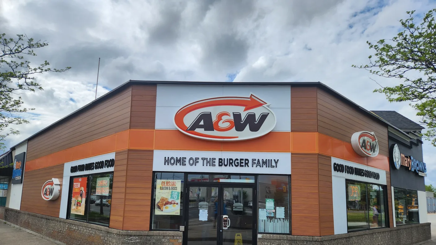 An A&W restaurant with drive-thru, seen from the parking lot
