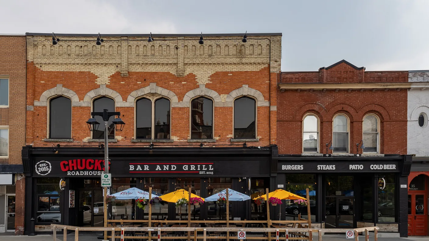 Chuck's Roadhouse in a red brick heritage building with a patio out front