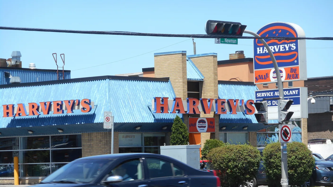 A Harvey's restaurant with blue awnings and the orange wordmark