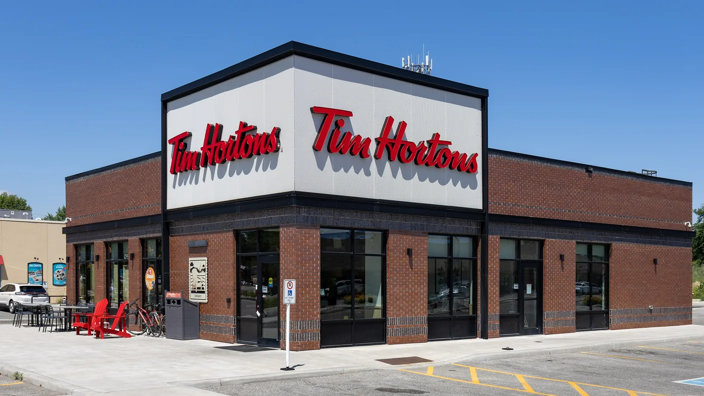 A Tim Hortons restaurant in dark brick with the red script sign