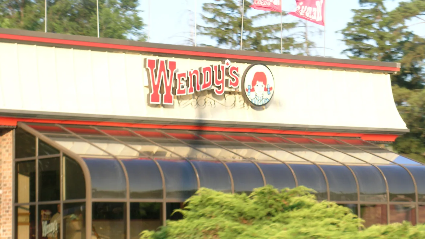 A Wendy's restaurant front with the red wordmark on the awning